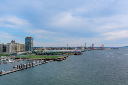 Vibrant harbor shows container ships alongside marina downtown Brooklyn under an overcast sky in NYC...