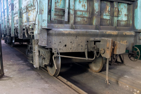 Weathered train car rests is under restoration in an industrial setting, reflecting years of use...