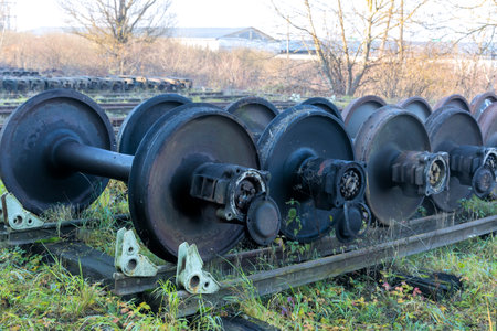 Old train wheelsets sit abandoned awaiting inspection is under restoration on transportation maintenance railway yardの写真素材
