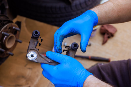 Technical worker assembles, maintains vehicle mechanical component in service garage.の写真素材