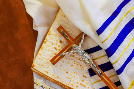 Crucifix on matzo bread, draped in tallit prayer shawl ceremonial cloth, symbolizes religious...
