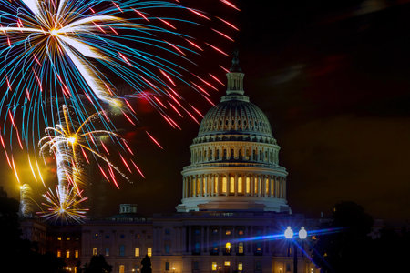 Fireworks burst above Capitol dome building during Fourth of July nighttime celebration in...