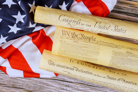 Founding documents of United States displayed on an American flag, illustrating key principles heritage.の写真素材