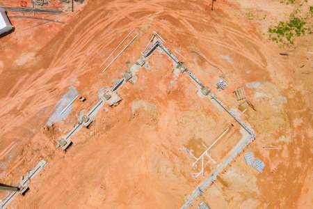 Workers are laying foundation for new building while equipment is construction site.の写真素材