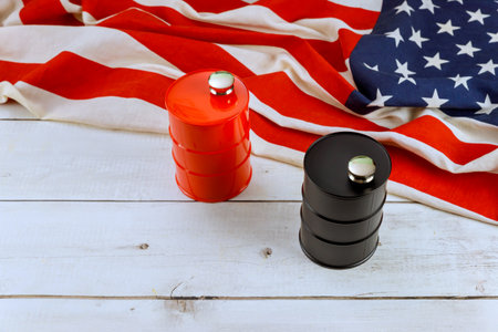 Fuel barrels sit on folded American flag, showcasing contrasting colors against rustic background.の写真素材