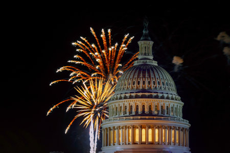 Colorful fireworks burst at night sky above US Capitol dome, creating festive atmosphere for event in Washington D.Cの写真素材