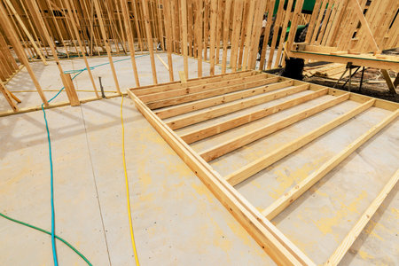 Workers are constructing wooden frame for foundation at construction site on work areaの写真素材