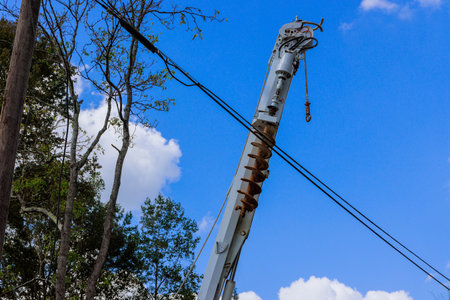 Utility operator truck to maintain power lines during electrician workers use an auger