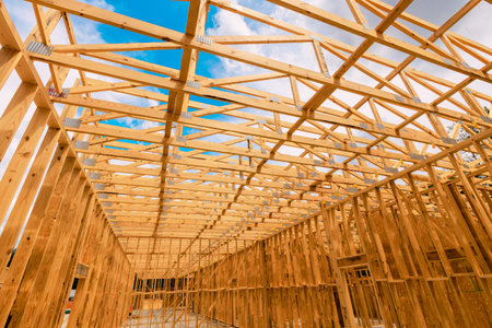 Wooden framing beams for building is visible at construction area under work site with scattered...