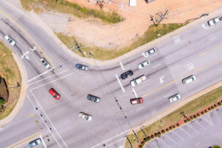 Aerial view of multi lane road intersection with multiple vehicles traveling in different directions...