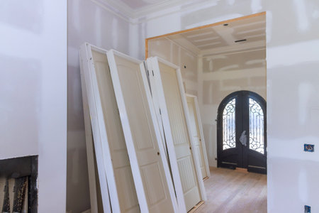 Interior construction several stacked doors against distinctive entry door in home under renovation.の写真素材