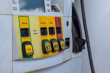 Fuel pump provides options for diesel, gasoline types at busy service station during daytime.