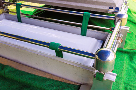 Casket placed on ceremonial stand during an outdoor funeral service held in cemetery during solemn...