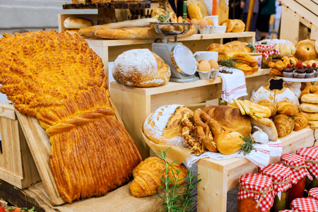 Colorful baked goods like bread, pastries, desserts featured at market of local artisan products.