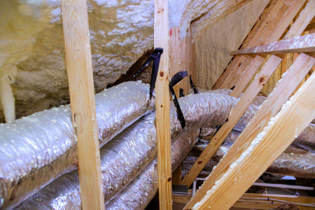 Install silver insulated ducting in attic of home, improving energy efficiency for heating cooling.