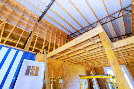 Construction underway inside building, wooden beams scaffolding in construction zone