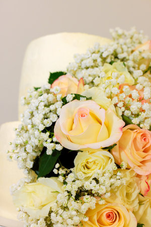 Stunning arrangement features soft pastel roses baby breath, perfect for celebrations or special events.の写真素材
