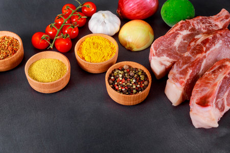 Ingredients including raw meats, vegetables, various spices arranged for preparing barbecue.の写真素材