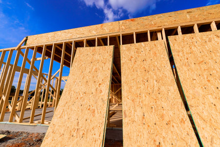 Wooden framing is being installed at construction site under beams framework during works day.
