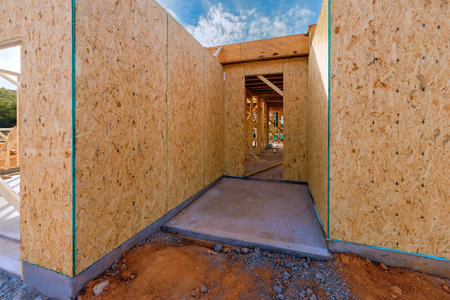 Unfinished walls frame an entrance at during build new house construction area