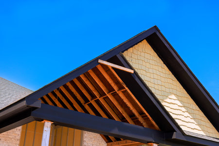 Workers repair roof of house, showing wooden framework build new houseの写真素材