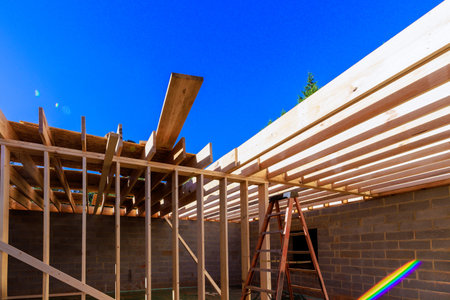 Workers build wooden roof structure beams new house under works framework dayの写真素材