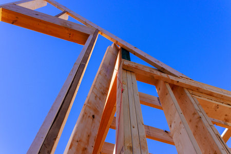 Workers are constructing building, framing wooden beams under work dayの写真素材