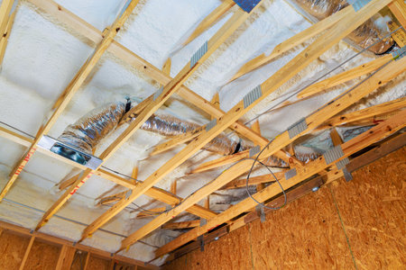 Wooden beams framework duct work of ceiling in new home under construction.