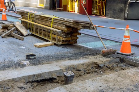 Road construction is taking place with tools materials set up along street for repair work.の写真素材