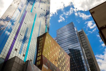 Manhattan skyline, tall buildings reflect clouds blue sky in busy city modern architecture urban...
