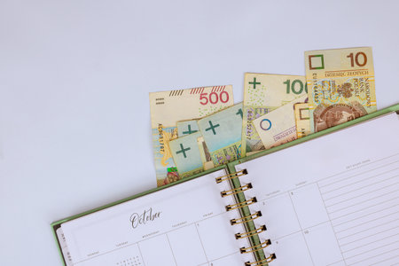 Polish zloty cash is displayed alongside planner, budgeting financial planning for month of October.の写真素材