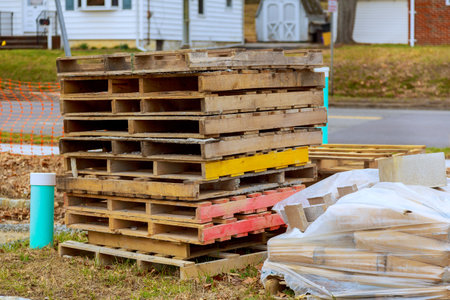 Stack of wooden pallets pile of bricks near construction site in suburban areaの写真素材