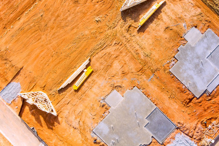 Sections of concrete slab are placed on dirt lot where a new house will be built.の写真素材