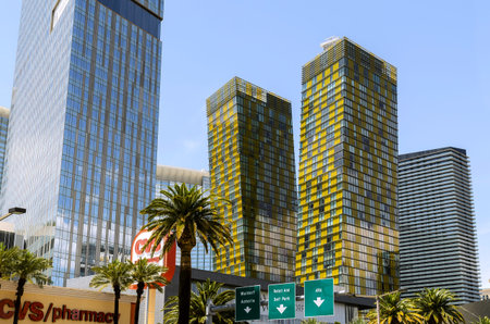 8 February 2026 Las Vegas NV USA Tall buildings with glass windows stand near palm trees under clear...