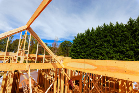 Workers build wooden framework for structure, surrounded beams frame at construction area