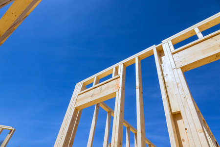 Workers are building wooden beams frame for new house structure while carpentry work framing job