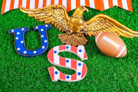 Patriotic symbols American football placed on green grass for super bowl sports event celebration.