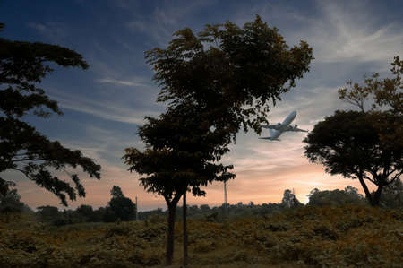 Flying plane in sky with sunset, sunrise