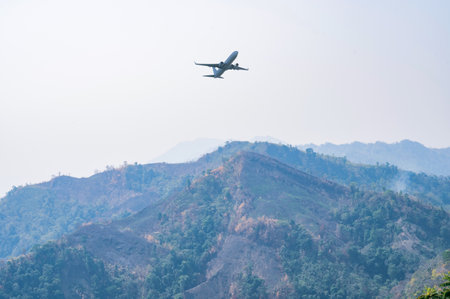 Airplane flying over the mountain at Bandarban, Bangladeshの写真素材