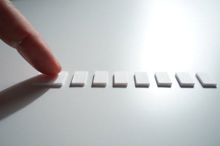 Rectangular white pieces. Hand touching. Close up of items.の素材