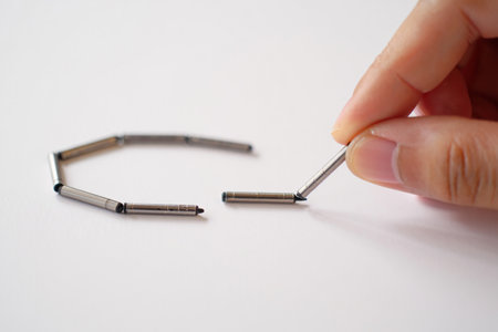 Hand connecting cylinders. Metal design. Assembly process. Chain link concept.の素材