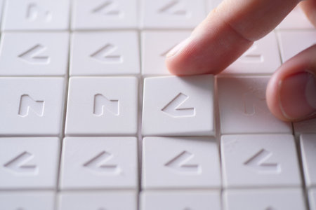 Arrow tile on white surface. Symbol maze and arranging for strategy. Strategic direction selection.の素材