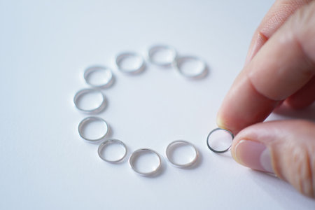 Arranging silver metal rings. Precision assembling circular design.の素材