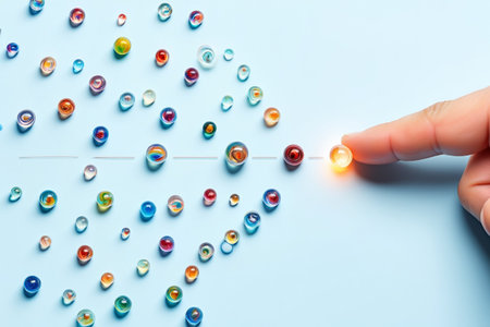 Pointing finger leading glass marble away from crowd. Abstract modern art directional.の素材