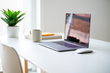 Laptop on desk. Home office workspace. Comfortable and productive environment.の素材
