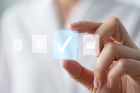 Holding checkmark icon. Digital confirmation. Selection element.の素材