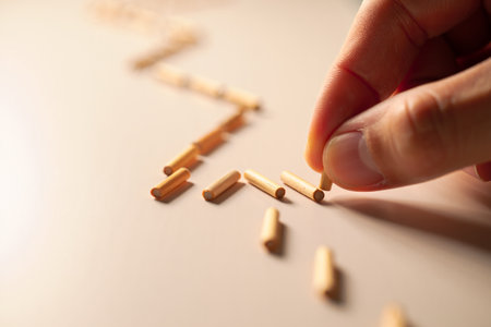 Hand arranging wooden dowels. Structure progression connection logic pathの素材