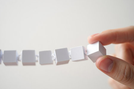 Hand picking white cube. Choice uniqueness and individuality arranging objects.の素材