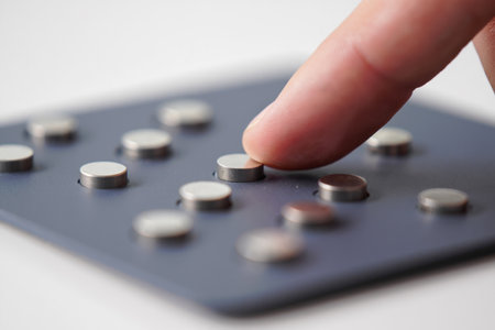 Mini silver metal discs. Grey pad. Finger pressing. Tech componentsの素材