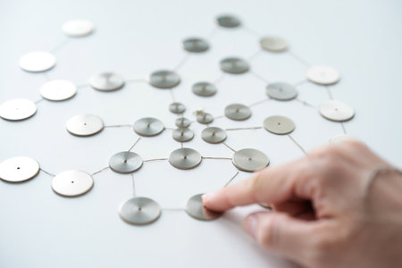Finger touching circle disk. Connected by metal wire. Networking concept.の素材
